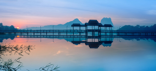 Amazing park landscape panorama at sunrise. Bridge and pavilion on lake at Hpa-An, Myanmar (Burma) travel landscapes and destinations