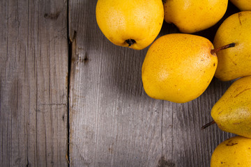 Fresh ripe organic yello pears on rustic wooden table, natural background, diet food.