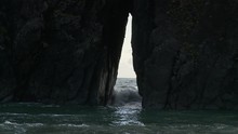 Ocean Water Gushing Through Hole In Rocks