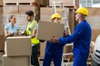 © WavebreakMediaMicro - Delivery worker unloading cardboard boxes from pallet jack