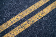 © Teeravat - Double strips lane road sign on asphault closeup