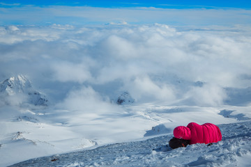 Tied climbers climbing mountain with snow field   a rope  ice axes and helmets