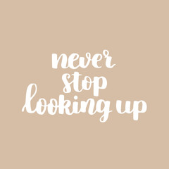 vector motivational quote. cute handdrawn lettering - never stop looking up. beige background.