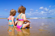 Two little girls on the beach.