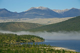 Fototapeta Desenie - Band of mist over a mountain lake. Lake Darpir, Cherskogo Ridge, Yakutia, Russia.