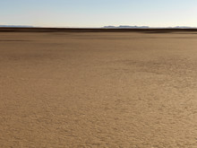 Flat Arid And Barren Landscape With Some Mountains In The Distance