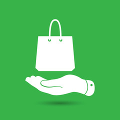 Wall Mural - flat hand shows the shopping bag icon - vector illustration