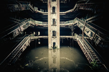 Dramatic View Of Damaged Escalators In Abandoned Shopping Mall Sunken By Rain Flood Waters. Apocalyptic And Evil Concept