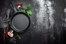 Cast Iron Pan And Spices On Black Metal Culinary Background, View From Above