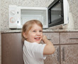 © DariaTrofimova - child without   parents playing with microwave