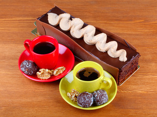 chocolate cake with two cup of coffee and chocolate balls