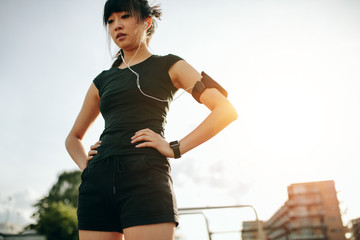 Female runner taking a break outdoors