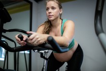 Pregnant Woman Working Out On Exercise Bike