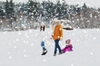 © Syda Productions - happy family with sled walking in winter forest