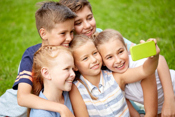 Canvas Print - happy kids or friends taking selfie in summer park