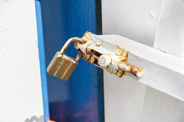 closed padlock in scratched metal latch