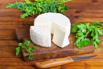 Soft salty cheese on a wooden table