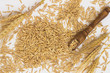 Oats are scattered on the table, wooden spoon, wheat and barley