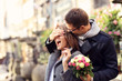 © Kalim - Young man surprising woman with flowers