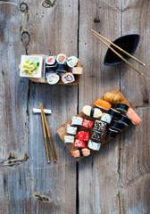 Wall Mural - A variety of sushi and green tea set on rustic wooden table.