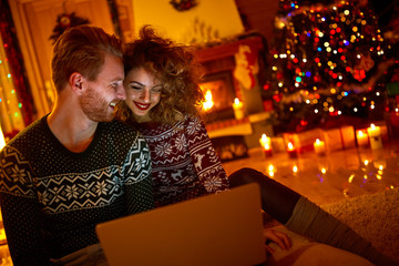 Young couple looking on laptop