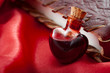 Love potion leaning on a book of magic spells for Valentine's day
