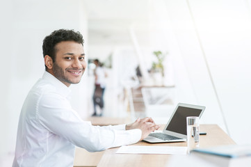 Wall Mural - Attractive young man is working on a computer