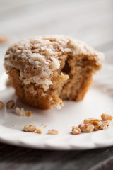 Walnut crumb sweet potato muffin with a bite taken out of it