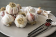 © The Picture Pantry - Plate of garlic bulbs and spoons of spices