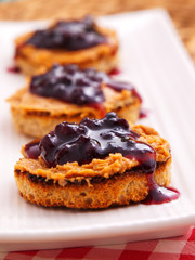 Wall Mural - Toasts with peanut butter and cranberry jam. Vertical shot