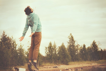 young man flying levitation jumping outdoor relax lifestyle happ