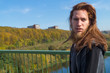 © Rob Rye - Portrait of man with a long beard and a long hair near the river