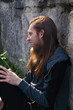 © Rob Rye - Portrait of man with a long beard and a long hair near the wall