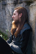 © Rob Rye - Portrait of man with a long beard and a long hair near the wall
