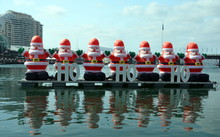 A Bunch Of Inflated Santa Claus Are Decorating The Darling Harbour Area In Downtown Sydney During The Christmas Holidays.