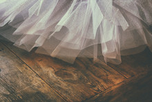 White Ballet Tutu On Wooden Floor. Retro Filtered