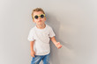 © Yakobchuk Olena - Little boy in sunglasses posing in studio