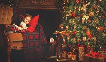 Little Child Girl Sleeping Near A Christmas Tree