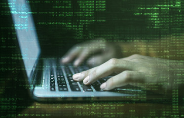 hacker hands at work with graphic user interface around
