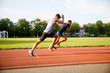 © snedorez - Two sports fast-running men on track outdoors