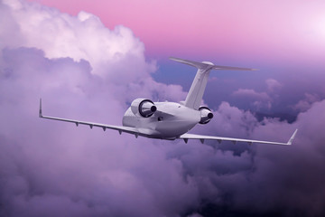 Wall Mural - Airplane flying at purple sunset over clouds