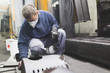 © hedgehog94 - Metallurgy industry. Factory for production of heavy pellet stoves and boilers. Manual worker sandblasting parts before panting.