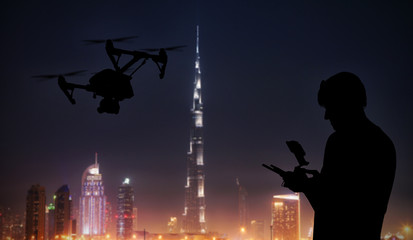 Wall Mural - man handling drone with modern city on background