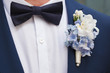 Blue and white boutonniere in blue suit of the groom 