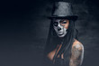 © Fxquadro - A woman with skull make up in top hat on Halloween.