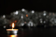© helgaknut - Candle and christmas tinsel