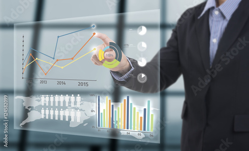 Cuadros en Lienzo Businessman touching financial analysis graph with key performance indicators on virtual screen