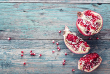 Fresh Juicy Cut Pomegranate On A Wooden Vintage Background. Free
