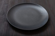 black plate on dark brown table