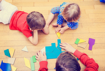 Wall Mural - teacher and kids playing with geometric shapes